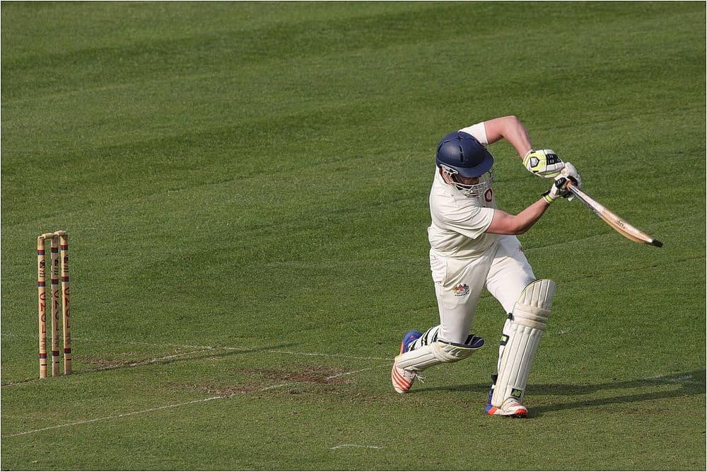 Cricket batsman playing a shot during a match